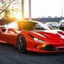 red ferrari 458 italia on road during daytime